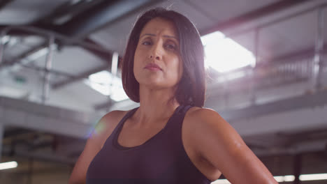 Portrait-Of-Mature-Woman-Wearing-Fitness-Clothing-Standing-In-Gym-Ready-To-Exercise